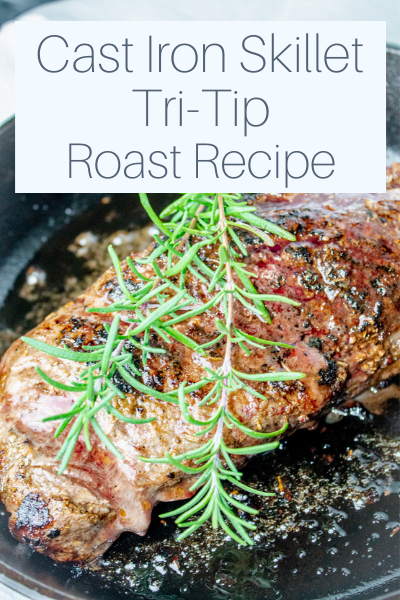 Cooked tri tip roast in a cast iron skillet with springs of rosemary on top and text overlay "Cast Iron Skillet Tri-Tip Roast Recipe"