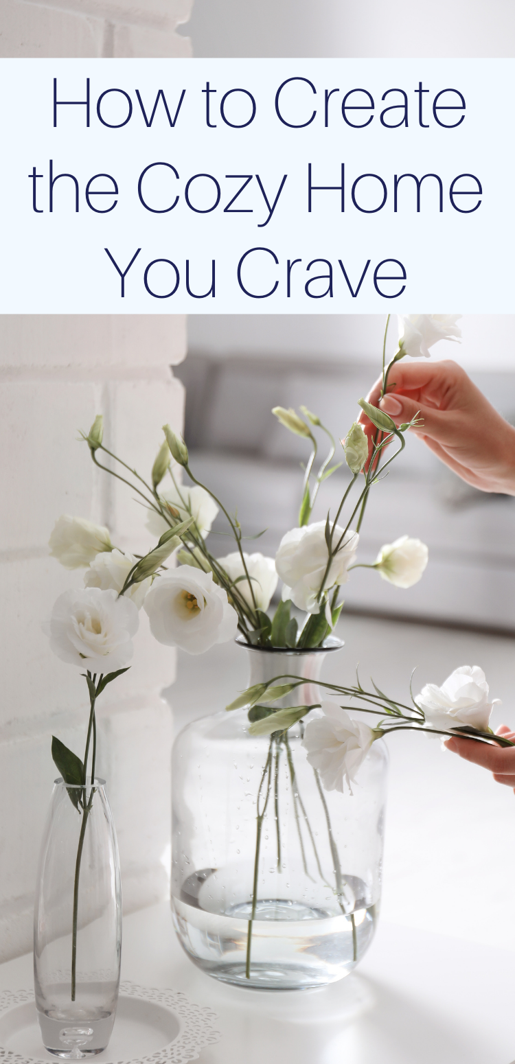 Woman taking beautiful flowers from vase indoors, closeup with text overlay "How to Create the Cozy Home You Crave"