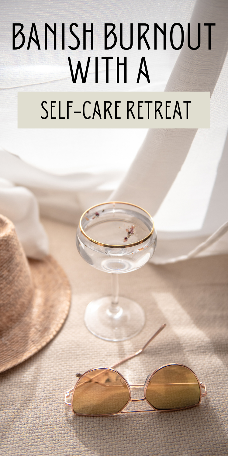 vacation scene with straw hat, champagne glass, and sunglasses on a beach blanket with text overlay "Banish burnout with a self-care retreat"