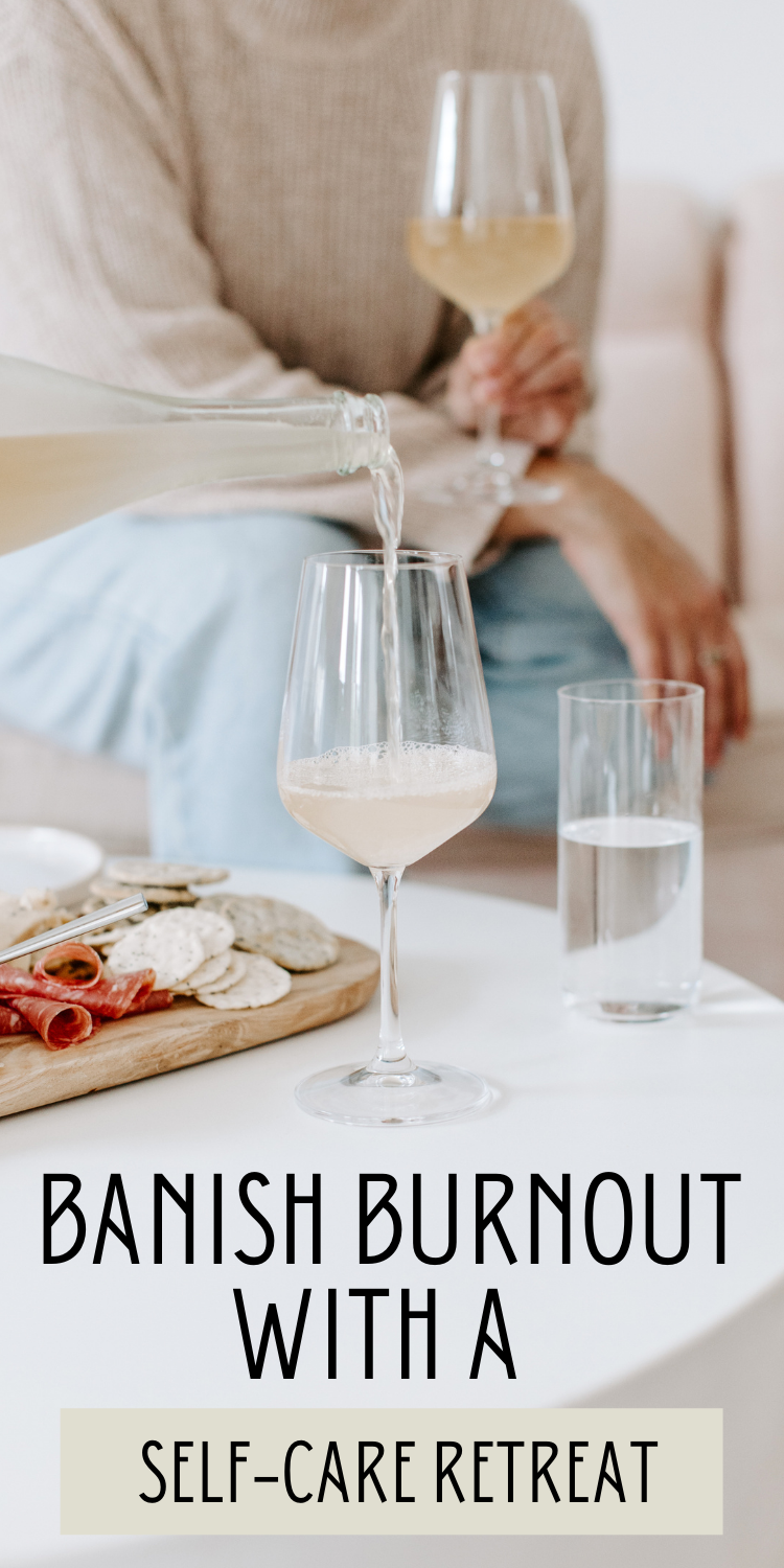 non descript woman enjoying a glass of wine and charcuterie board while another glass of wine is being poured with text overlay "Banish burnout with a self-care retreat"