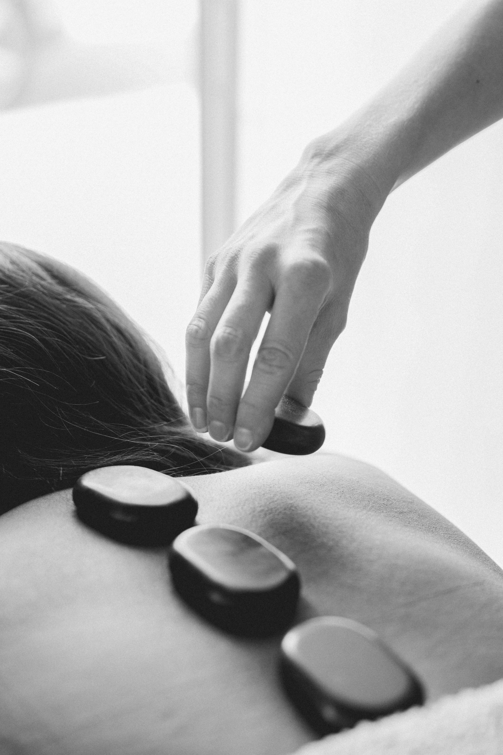 non descript woman getting a stone massage