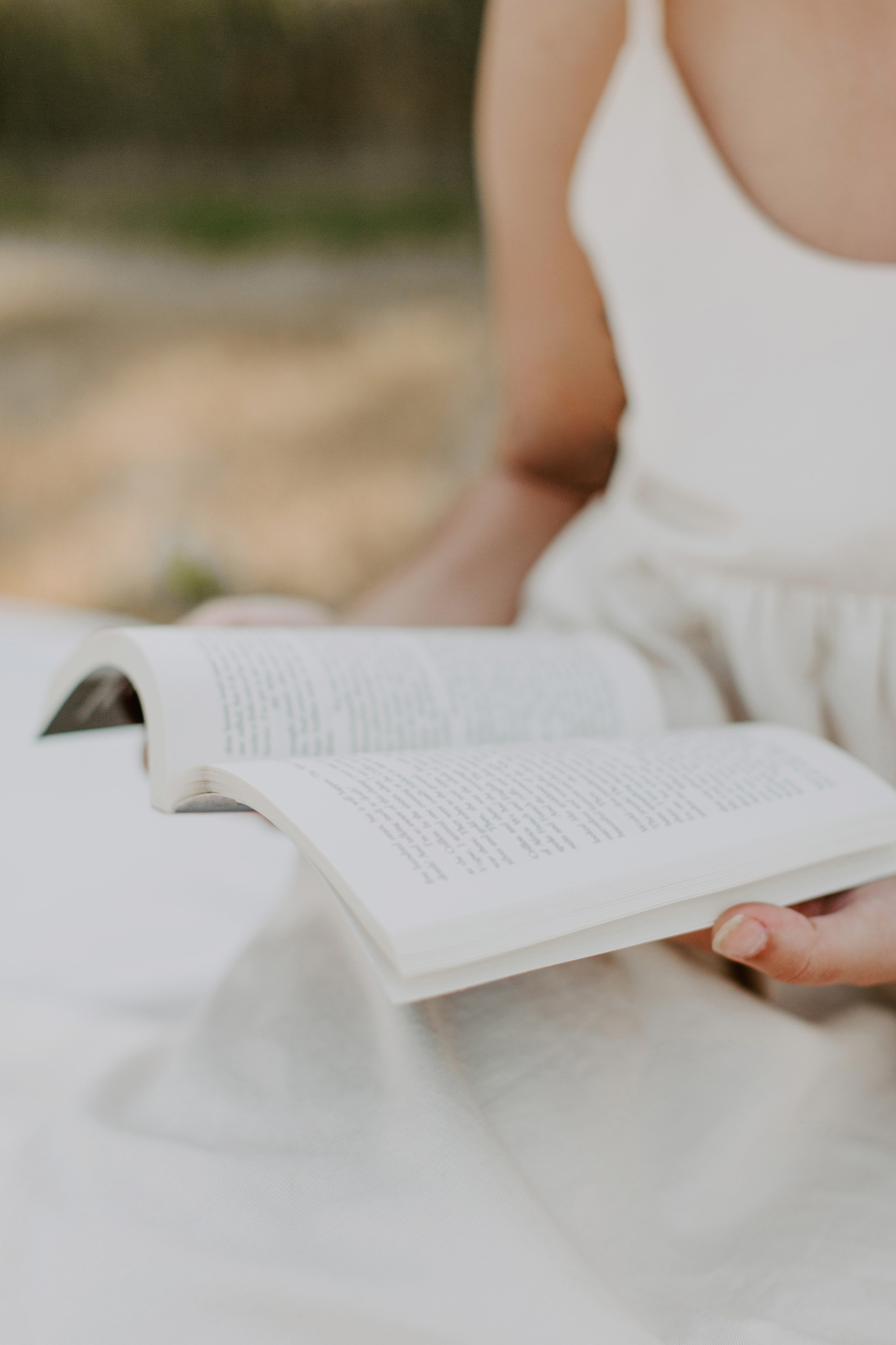 non descript woman relaxing and reading a book