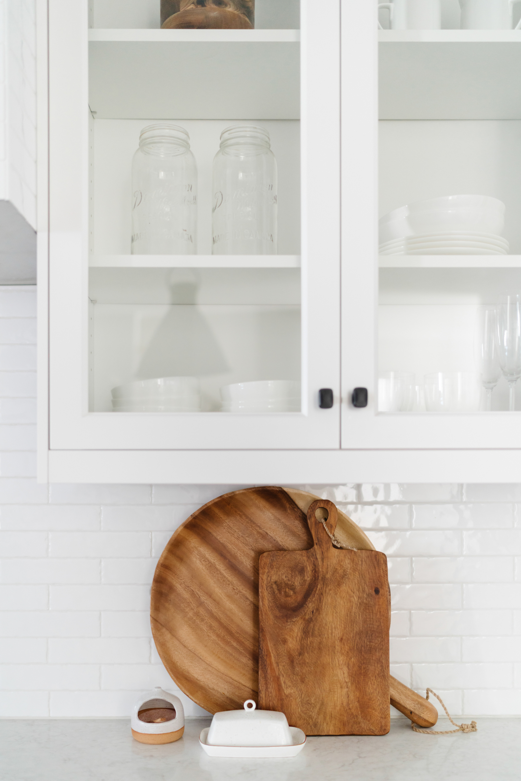 wooden cutting boards leaning up against a kitchen wall