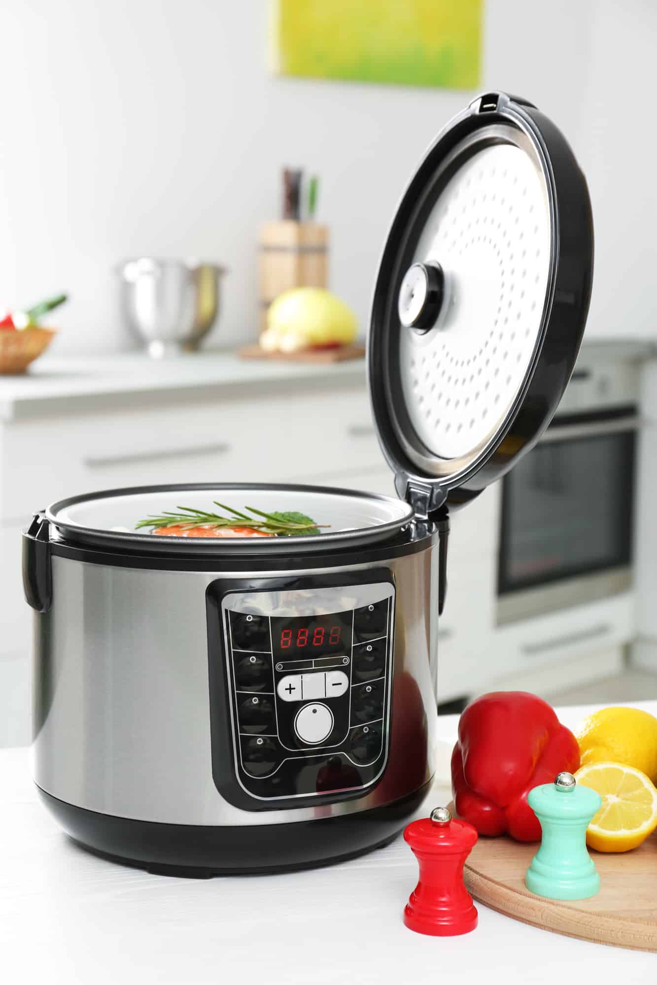 Modern multi cooker and products on kitchen table