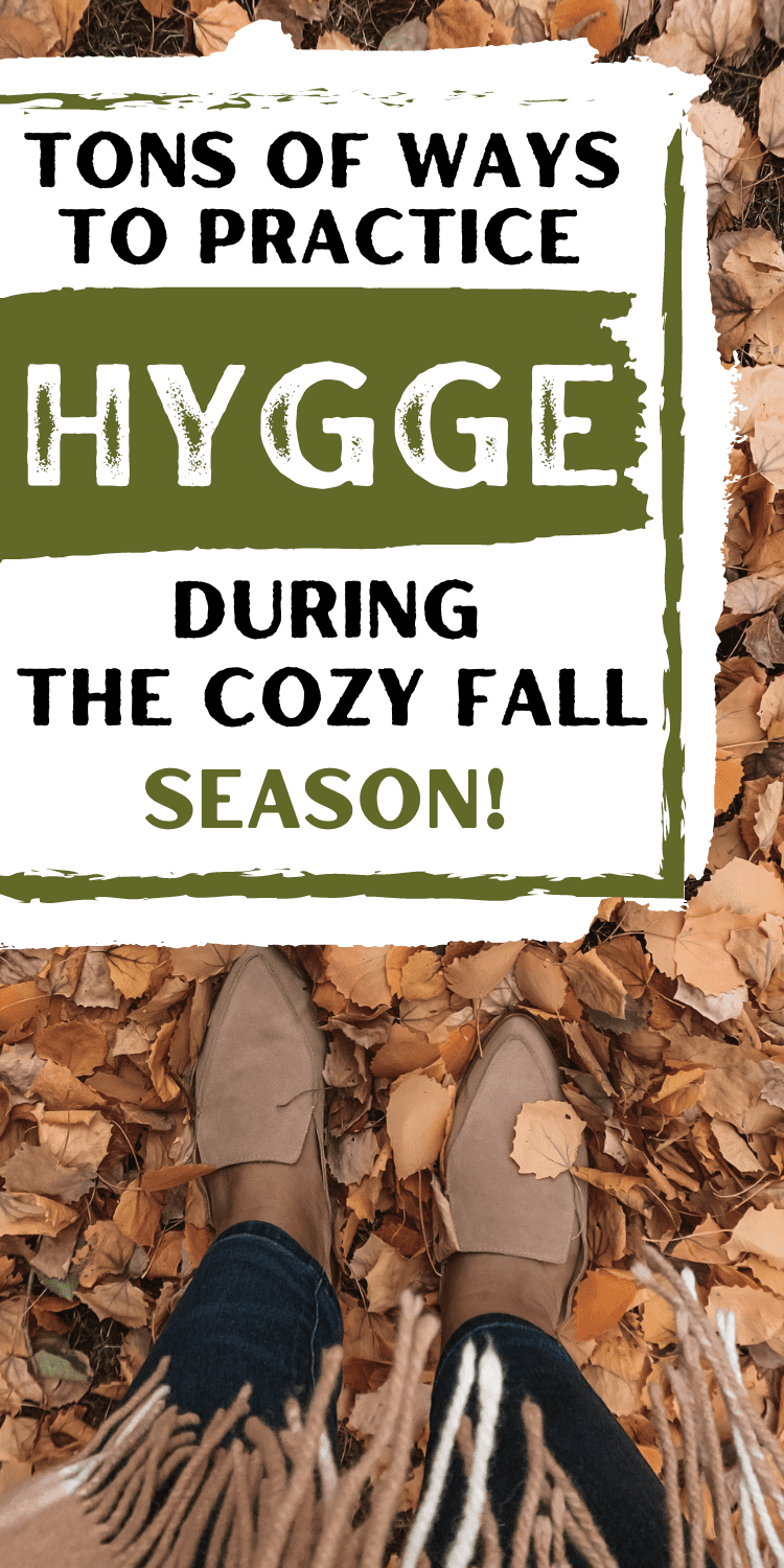 non dexcript woman's feet standing in a pile of fall leaves with text overlay "Tons of ways to practice hygge during the cozy fall season"