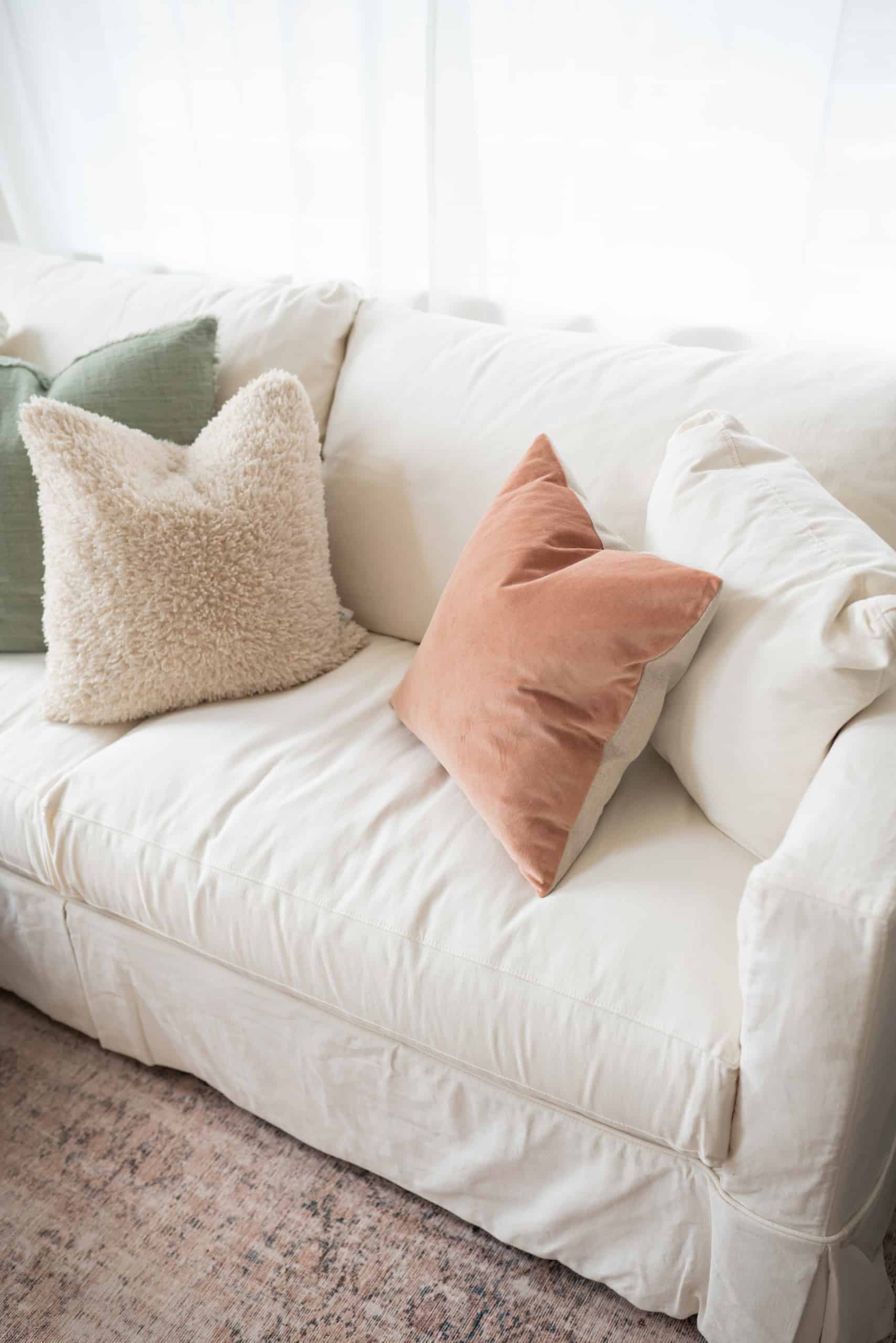 overhead view of slipcovered couch with 4 throw pillows