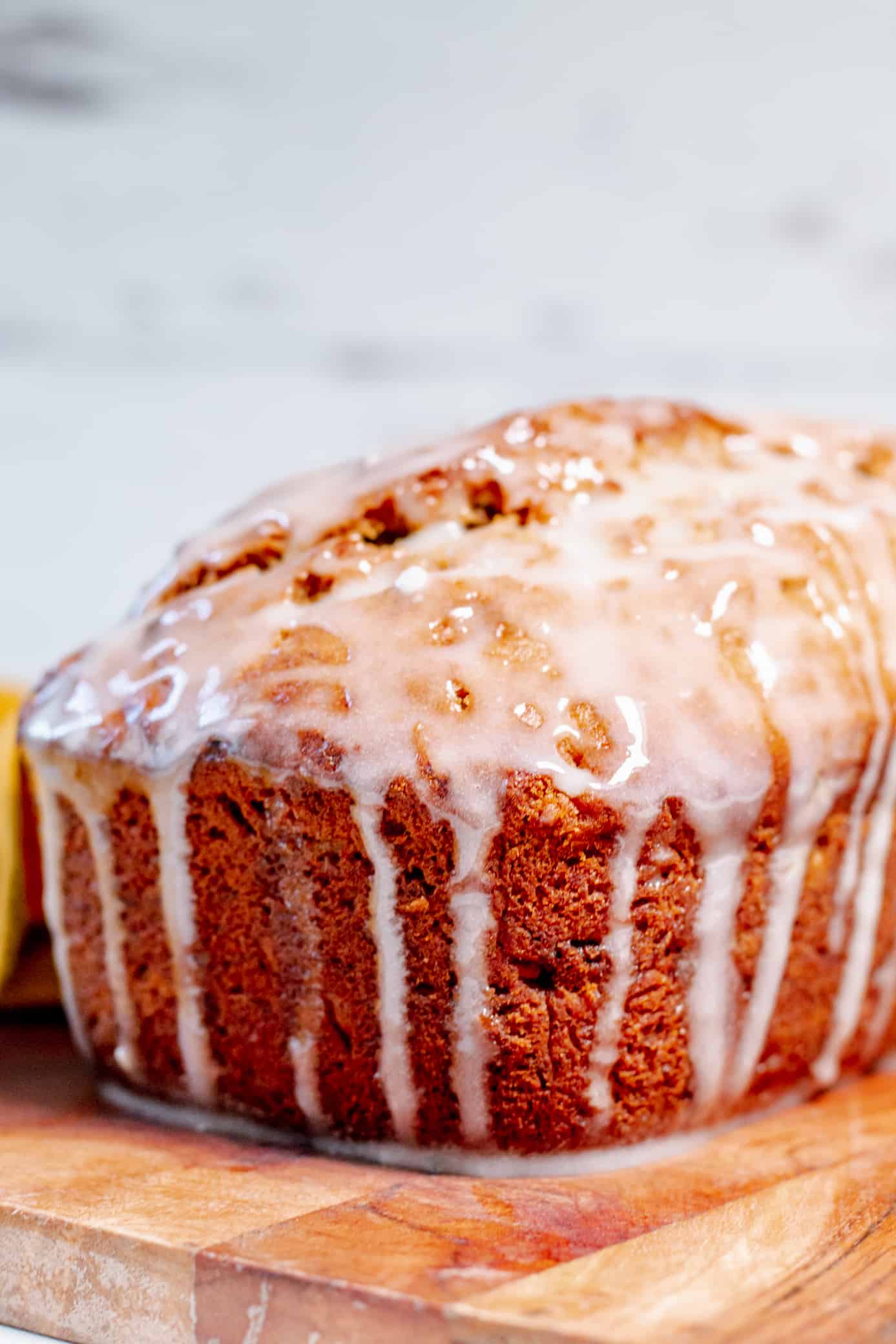 close up view of a loaf of bourbon banana bread covered in icing