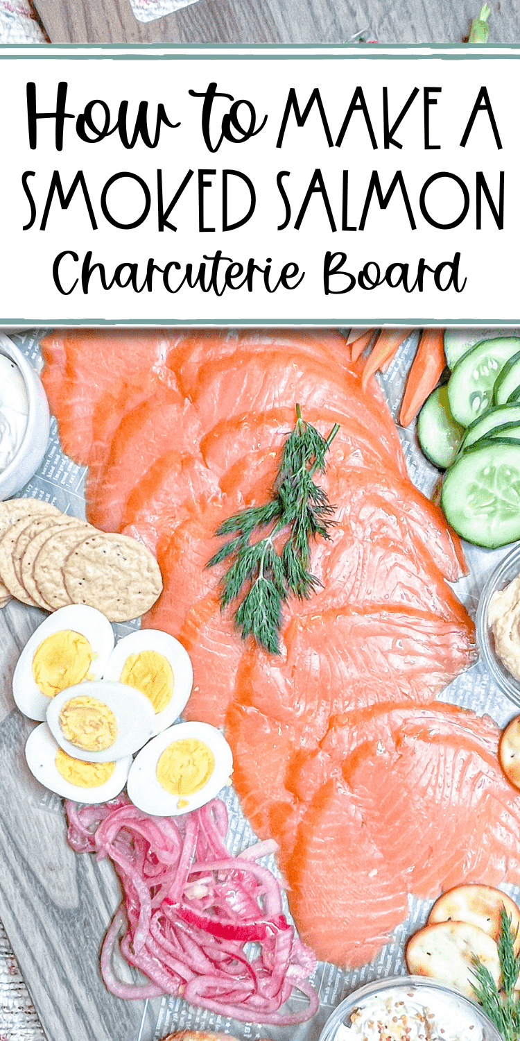 pinterest pin - overhead view of a charcuterie board with text overlay "how to make a smoked salmon charcuterie board"