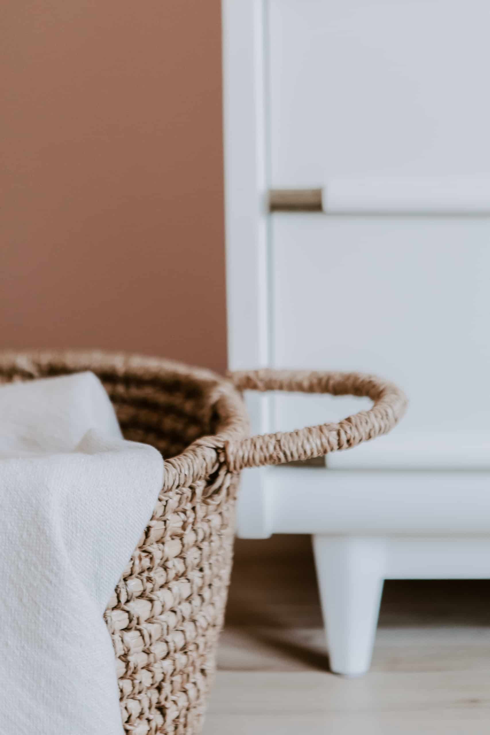 wicker basket with linen draped over it