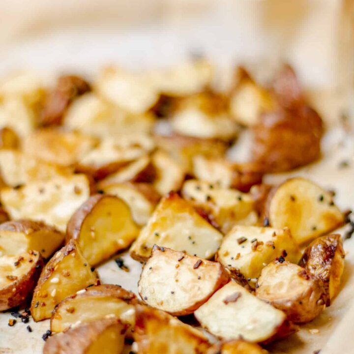 a pan lined with parchment paper and filled with roasted everything bagel potatoes
