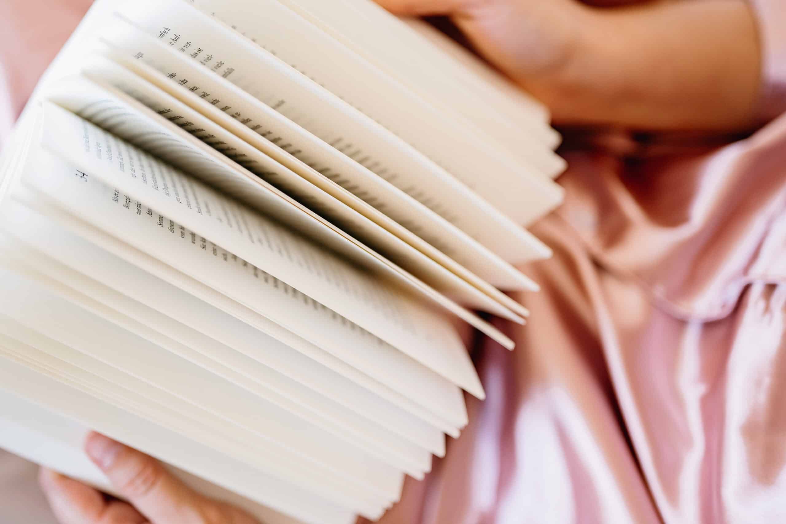 close up of a non descript woman leafing through a book