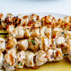 overhead view of lemon basil garlic butter chicken kabobs on skewers