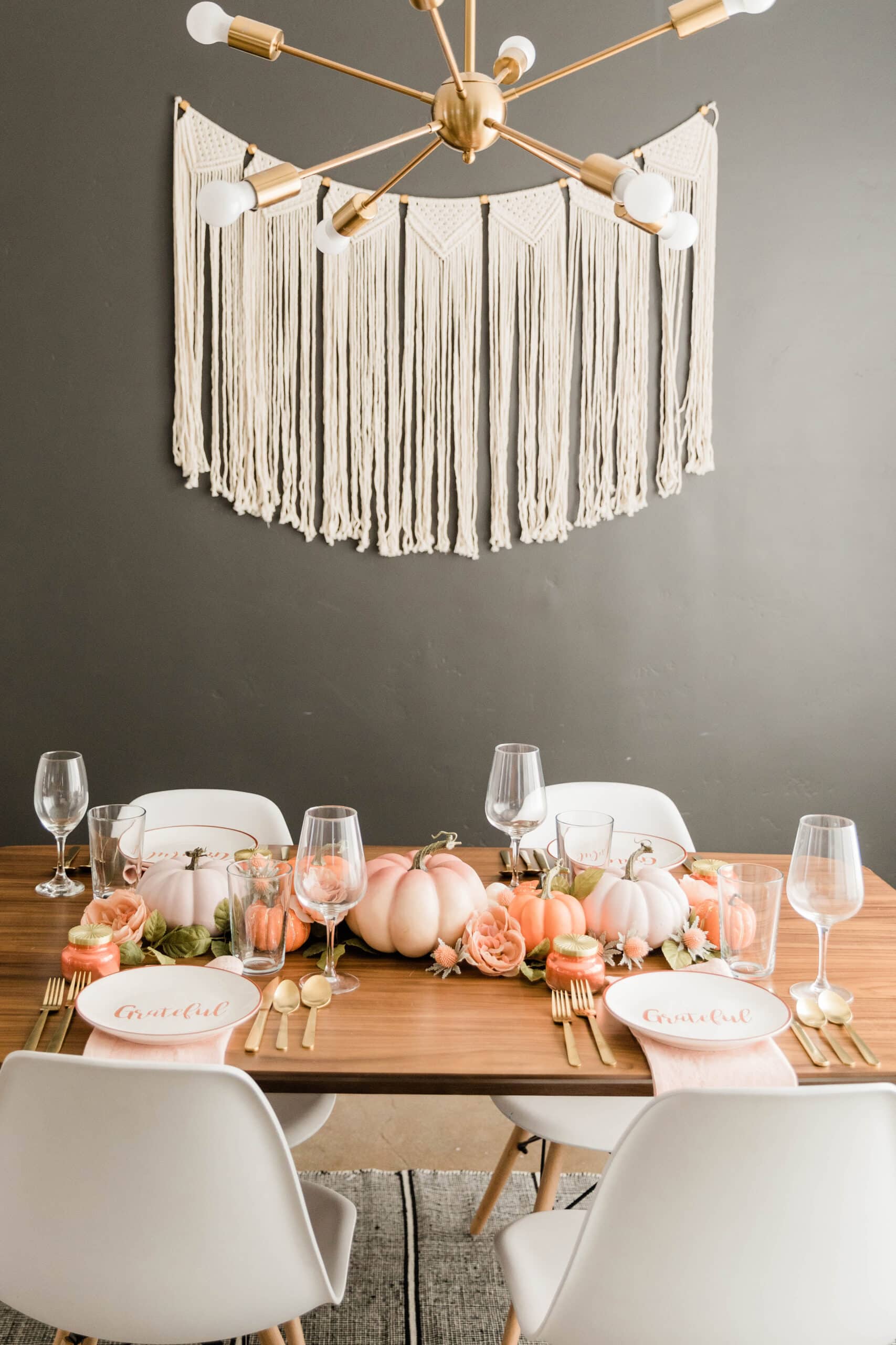 fall themed dining room table with tapestry on the wall