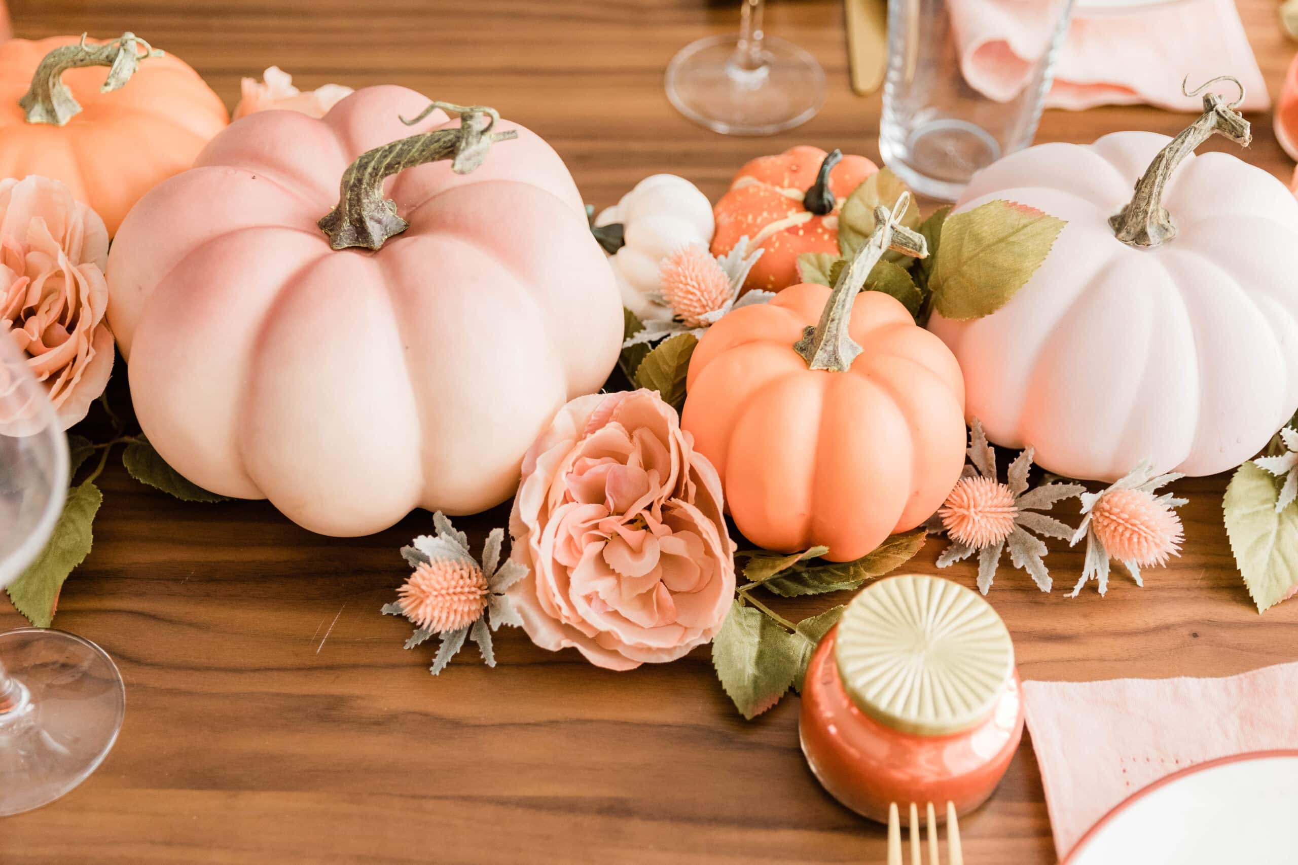 close up of fall themed pumpkin centerpiece on dining room table