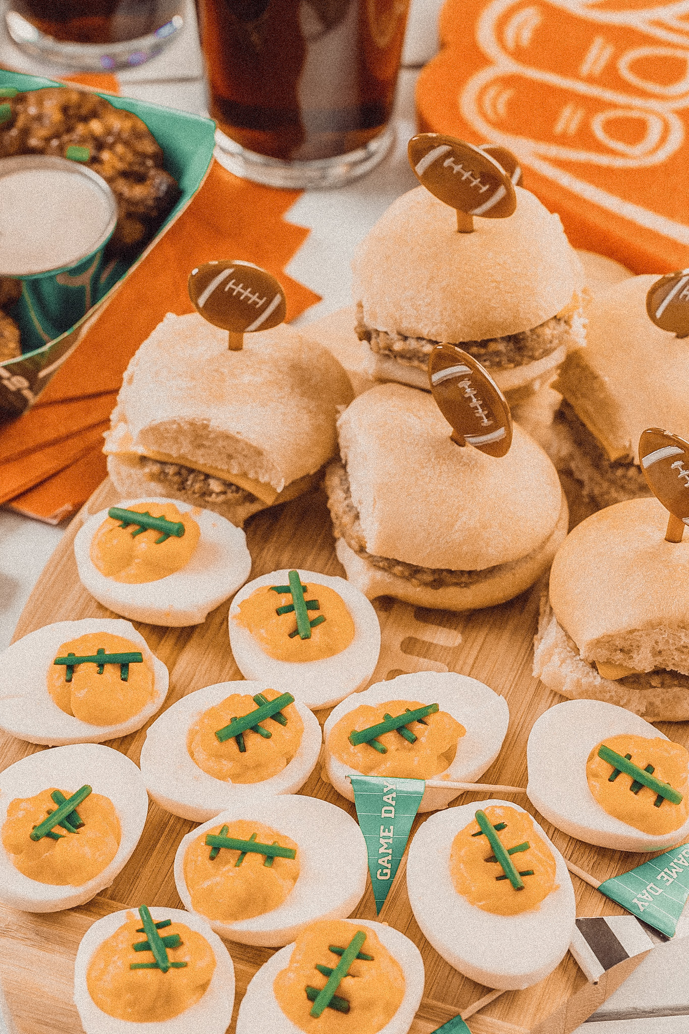 Gameday spread of footballl themed deviled eggs and sliders