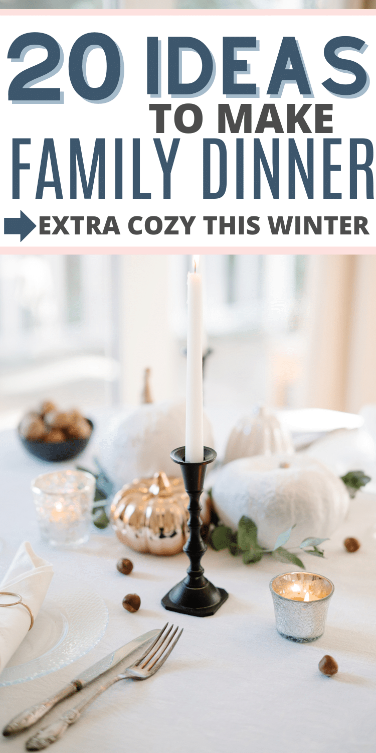 Text reads "20 IDEAS TO MAKE FAMILY DINNER --> EXTRA COZY THIS WINTER" above an image of a centerpiece with metal and fabric pumpkins, tealights, cranberries, and a single tall candle in an ornate black metal holder.