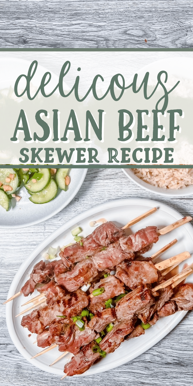 A table top holds plates and bowls full of cucumber salad, rice, and beef skewers seasoned with green onions.