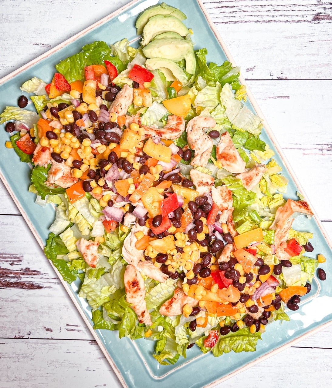 Overhead view of cowboy caviar salad on a blue serving tray