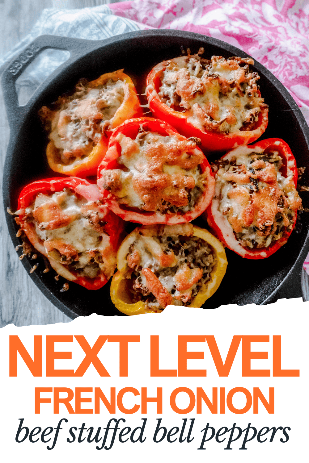 A black skillet filled with six bell pepper halves stuffed with beef, rice, and melted cheese. Text below reads: Next Level French Onion Beef Stuffed Bell Peppers.
