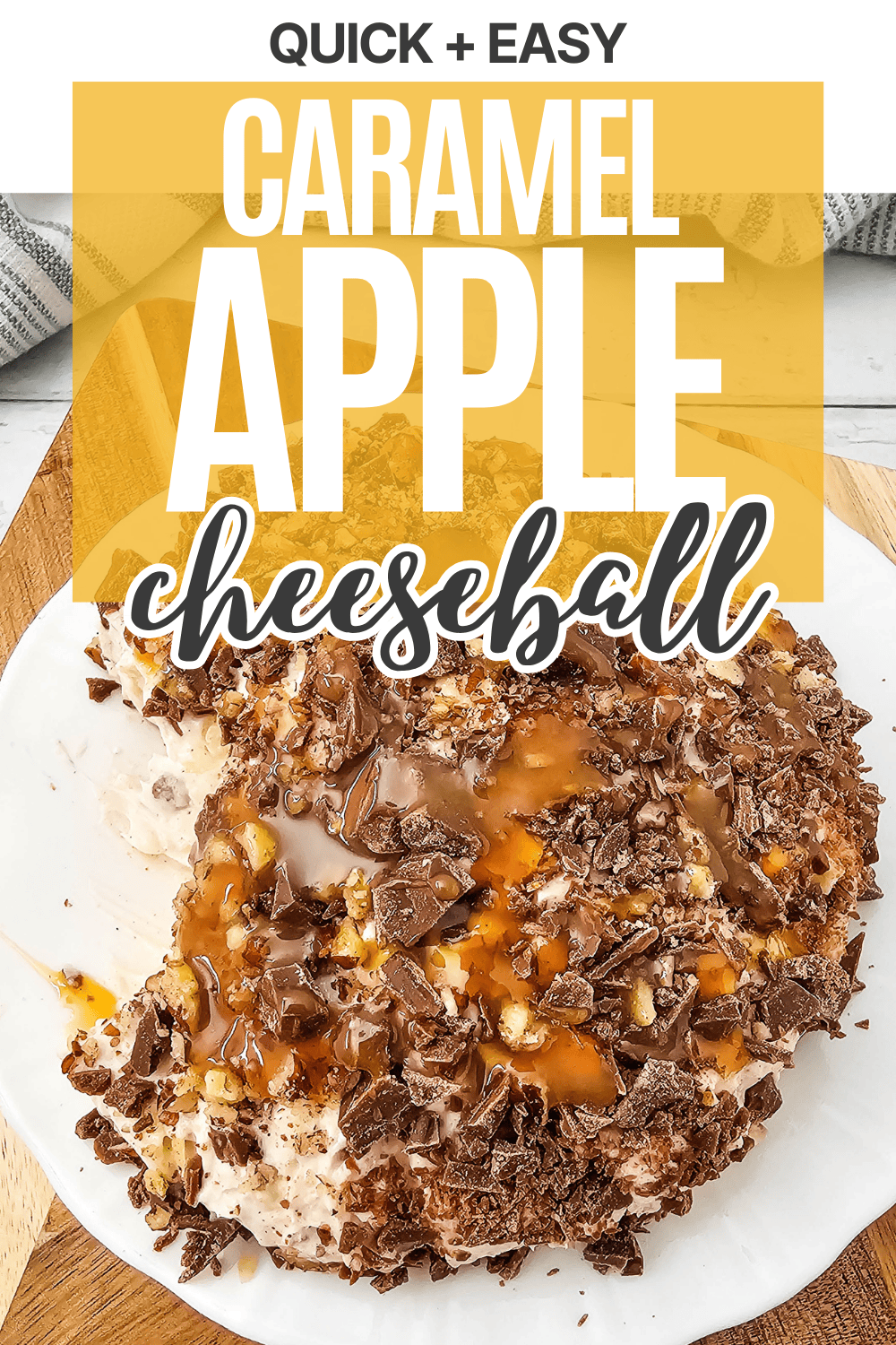A caramel apple cheeseball covered in chopped nuts and chocolate sits on a white plate, drizzled with caramel sauce. Text above reads “Quick + Easy Caramel Apple Cheeseball.”.