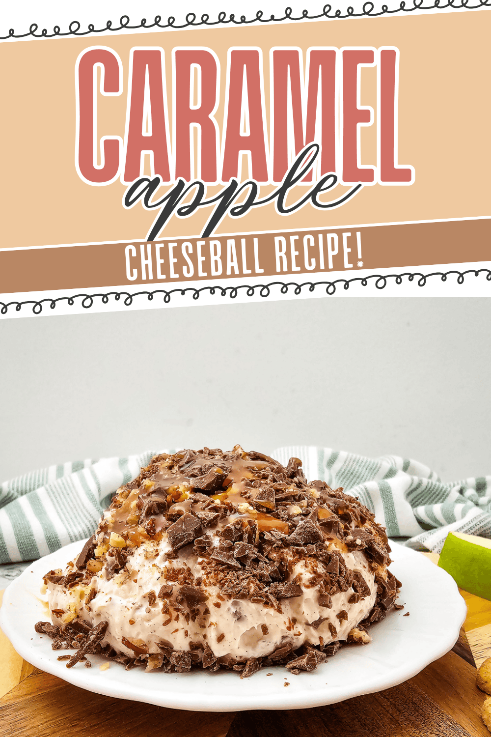 A caramel apple cheeseball covered in chocolate shavings sits on a white plate. In the background, there is a green-striped cloth and a couple of sliced apples. Text above reads: Caramel Apple Cheeseball Recipe!.