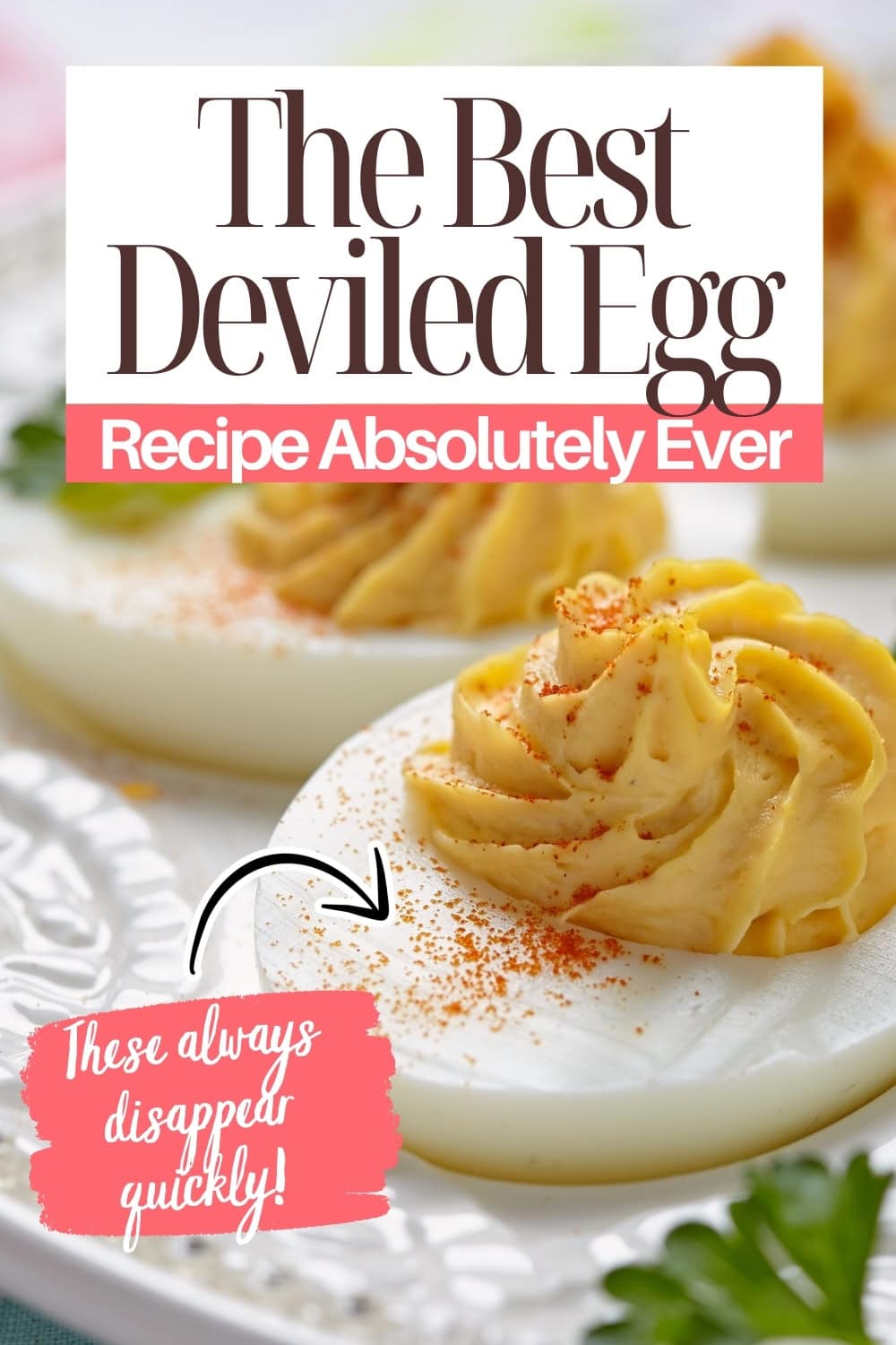 Close-up of deviled eggs with creamy, piped filling and a sprinkle of paprika, set on a white plate. Text overlay reads, “The Best Deviled Egg Recipe Absolutely Ever. These always disappear quickly!”.