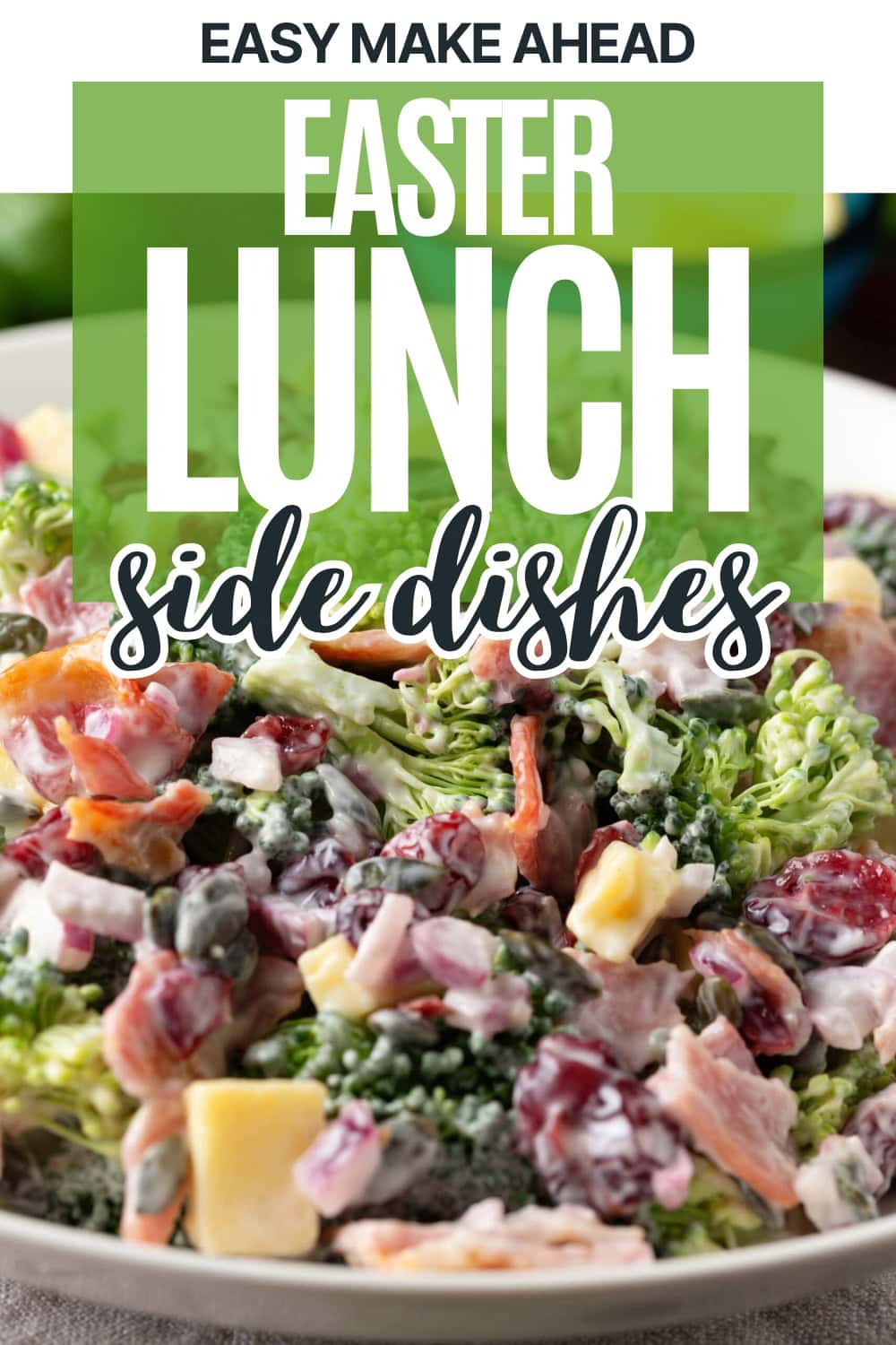 A close-up of a creamy broccoli salad with chopped apples, grapes, bacon, and carrots. The text on the image reads: “Easy Make Ahead Easter Lunch Side Dishes.”.
