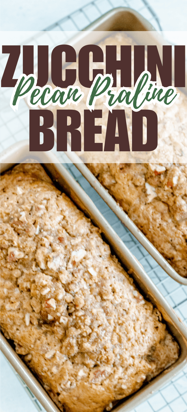 Two loaves of zucchini pecan praline bread in metal pans sit on a cooling rack. The bread is topped with chopped pecans, and the words “Zucchini Pecan Praline Bread” are written at the top.